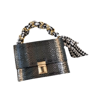 Fashion faux snakeskin handbag with gold chain and black white houndstooth scarf handle