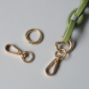 Detail of olive green acrylic wide chain strap with polished golden lobster clasps