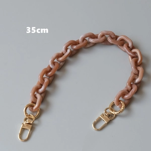 Detailed view of 35cm peach marble resin bag chain with gold metal lobster clasps