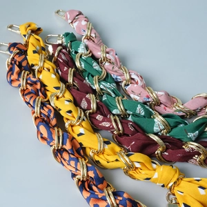 Detail of colorful silk scarf wrapped metal chain straps for handbags with gold lobster clasps