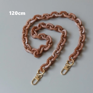 Detail view of a 120cm amber resin chunky chain with golden metal lobster clasps