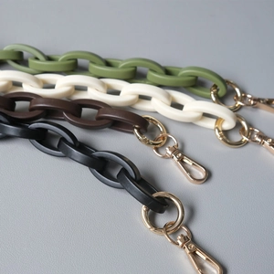 Detail view of colorful matte acrylic chain straps with golden lobster clasps for handbags