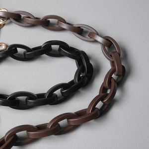 Close-up of interlocking matte resin chain links with gold metal lobster clasps