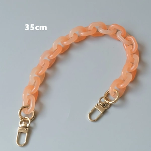 Close-up of 35cm orange acrylic bag chain with golden metal lobster clasps