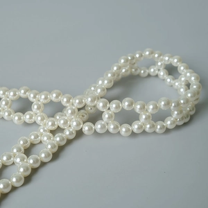 Macro shot of white pearl woven chain strap for elegant handbags and fashion DIY accessories