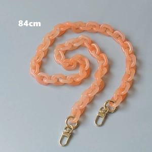 Detail showing 84cm peach orange acrylic phone chain with gold lobster clasps