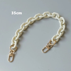 Detail view of 35cm cream resin acrylic bag chain strap with gold lobster clasps