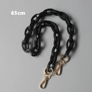 Detailed view of 65cm matte black acrylic bag strap with gold metal lobster clasps