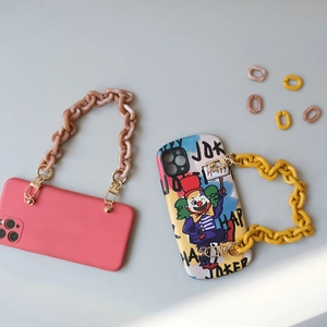 Detail of candy-colored acrylic phone chains with joker graffiti and matte cases