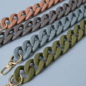 Detail of matte acrylic handbag chains in four Morandi colors with gold lobster clasps