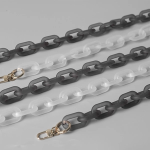Close-up of matte white and grey acrylic resin chain strap with gold metal lobster clasps