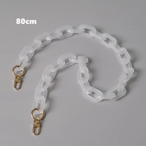 Close-up of 80cm matte white acrylic chain with gold metal rotating clasps on grey background