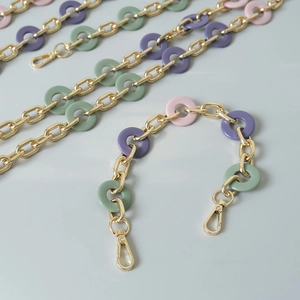 Detail of colorful resin rings and gold metal chain strap for bags with clasps