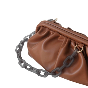 Brown ruched cloud clutch bag featuring a chunky grey frosted acrylic resin chain