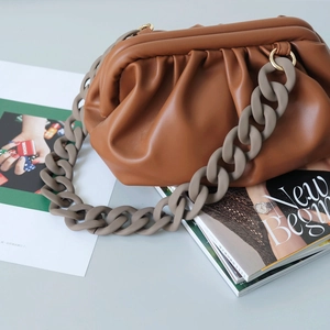 Brown pleated dumpling bag with chunky grey acrylic chain strap and soft leather texture