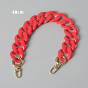 Close-up of a 40cm neon coral acrylic chunky bag chain with gold lobster clasps