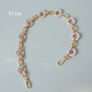 Close-up of pink acrylic resin rings with gold metal chain and clasps, length 57cm