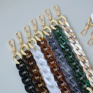 Detail of colorful acrylic fishbone chains with golden lobster clasps in various textures