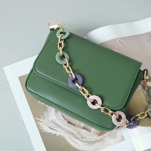 Green leather handbag with decorative gold metal and colorful resin chain strap