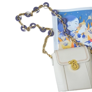 White leather shoulder bag with gold twist lock and purple resin link chain strap