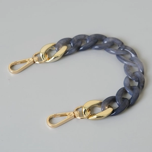 Detail of blue marble resin fishbone chain links with glossy gold lobster clasps