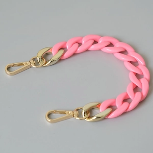 Detail of pink acrylic resin chain links with durable golden lobster clasps