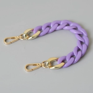 Macro detail of purple acrylic fishbone chain with premium golden metal lobster clasps
