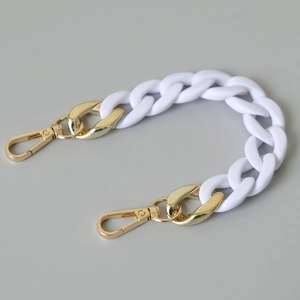 Close-up of white acrylic resin chain strap with premium gold metal swivel hooks