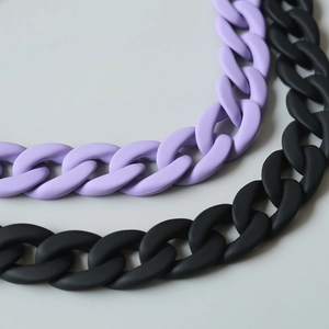Detail of matte purple and black chunky acrylic resin chain links for bag decoration