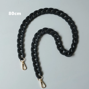 Close-up of 80cm matte black resin chain with gold metal lobster clasps for handbags