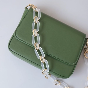 Green leather handbag with vintage acrylic chain strap and gold metal rings