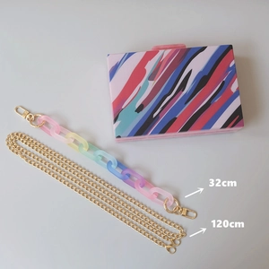 Colorful striped acrylic evening clutch bag with rainbow chain and gold shoulder strap