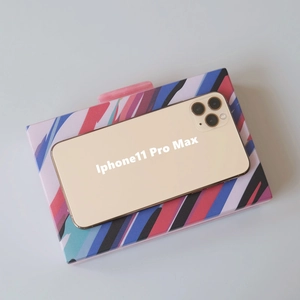 Colorful striped acrylic clutch bag size comparison with an iPhone 11 Pro Max