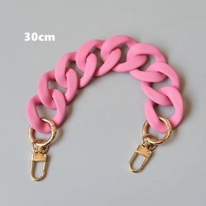 Macro detail of 30cm pink matte acrylic chain strap with gold metal lobster clasps