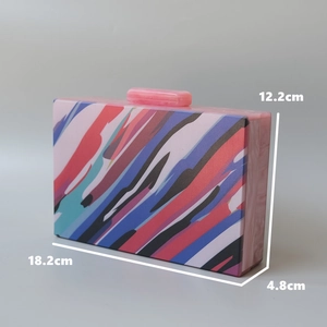 Detail view of acrylic clutch bag featuring vibrant abstract stripes and dimensions
