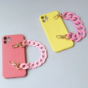Pink and yellow liquid silicone phone cases with chunky acrylic chain wrist straps