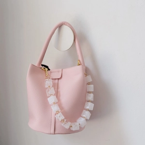 Pink lychee grain bucket bag featuring a decorative acrylic ice cube link chain