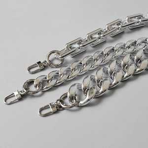 Close-up of assorted silver metal bag straps with lobster clasps and Cuban links
