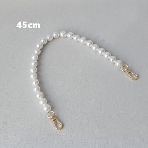 Detail of 45cm white faux pearl handbag chain with polished gold lobster clasps