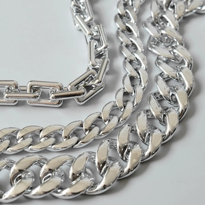 Macro detail of high-polished silver metal Cuban link and rectangle chain strap