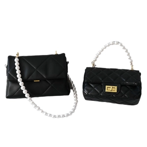 Elegant black quilted leather handbags with decorative pearl straps and metallic turn locks