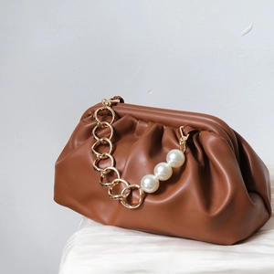 Brown ruched cloud clutch bag with elegant gold chain and decorative large pearl strap