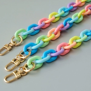 Macro shot of colorful acrylic resin chain links with golden metal lobster clasps