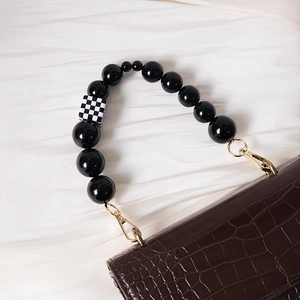 Vintage brown croc-embossed handbag with black acrylic bead handle and checkered bead accent