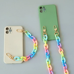 Colorful macaron acrylic chain straps with matte beige and green phone cases on grey surface