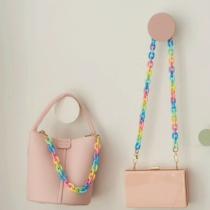 Detail of colorful matte macaron resin chain strap on two different pink crossbody handbags