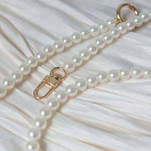 Elegant white pearl handbag chain strap with polished gold lobster clasps and rings