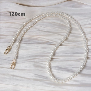Detail of 120cm white faux pearl handbag strap with gold lobster clasps and smooth finish