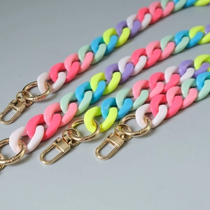 Detailed macro view of colorful macaron acrylic chain links with golden metal lobster clasps