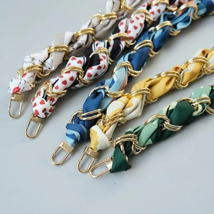 Detailed view of woven silk scarf handbag chains with gold metal links and lobster clasps